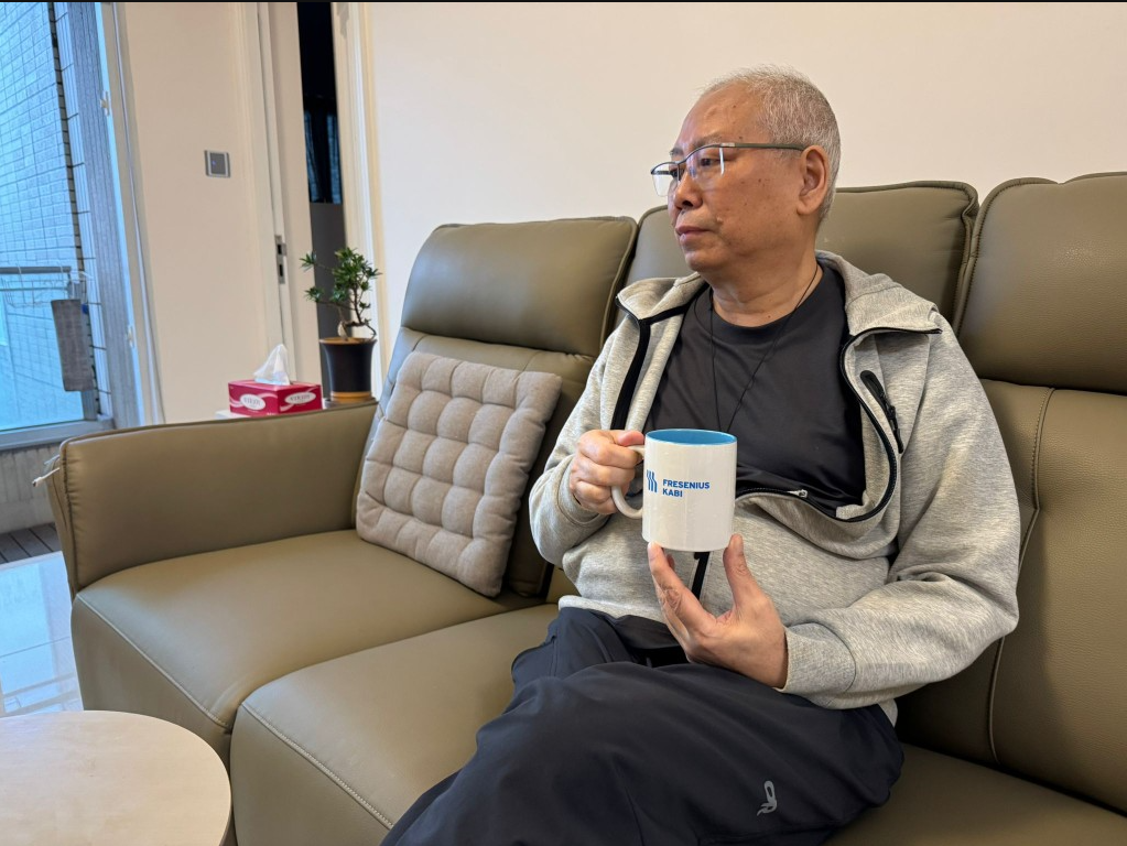 Mr. Lu holding a cup, reflecting on his treatment journey